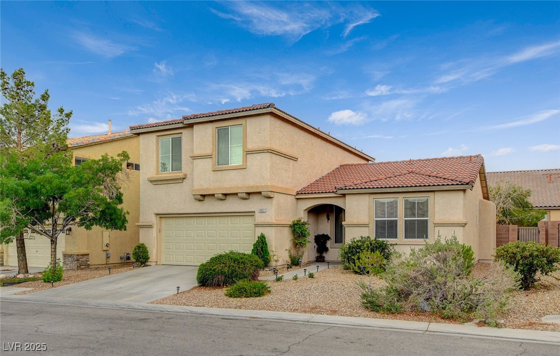 7427 Wagonwheel Ranch Way Las Vegas, NV 89113 - Photo 2 of 50 Mediterranean / spanish-style home featuring stucco siding, concrete driveway, a tile roof, and an attached garage