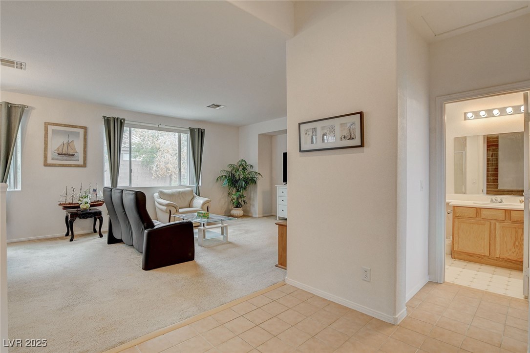 7427 Wagonwheel Ranch Way Las Vegas, NV 89113 - Photo 21 of 50 Living room with baseboards and light colored carpet
