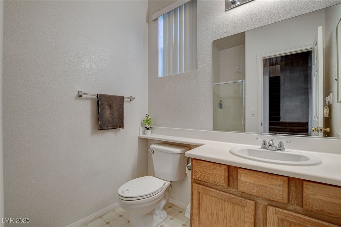 7427 Wagonwheel Ranch Way Las Vegas, NV 89113 - Photo 22 of 50 Full bathroom featuring vanity, a shower with door, and tile patterned floors