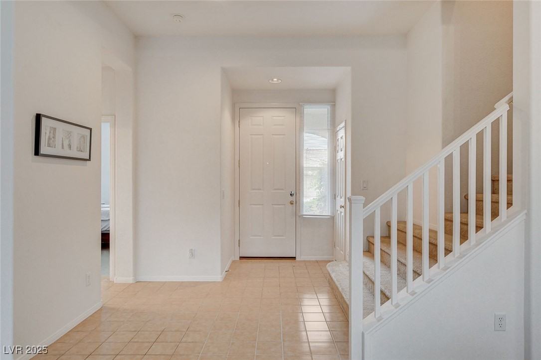 7427 Wagonwheel Ranch Way Las Vegas, NV 89113 - Photo 23 of 50 Entrance foyer featuring stairway and light tile patterned flooring