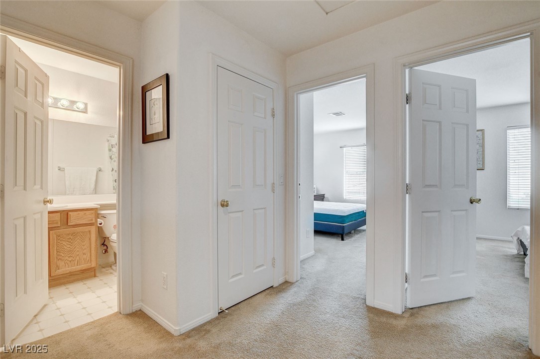 7427 Wagonwheel Ranch Way Las Vegas, NV 89113 - Photo 27 of 50 Corridor with light colored carpet and plenty of natural light