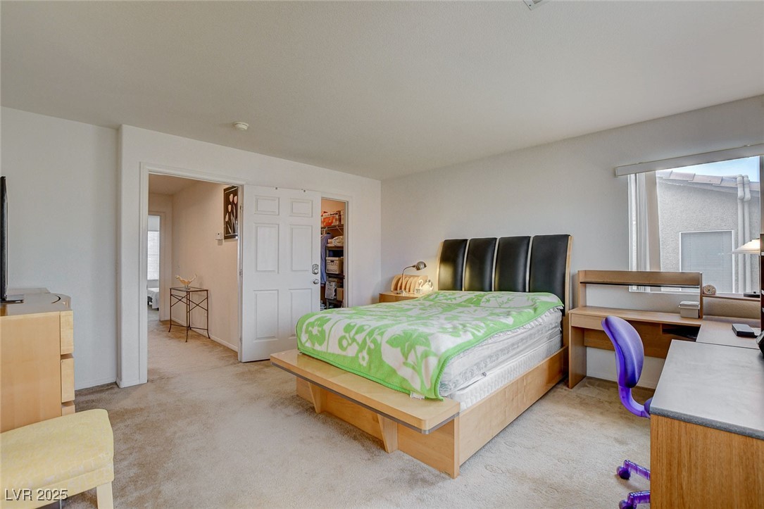 7427 Wagonwheel Ranch Way Las Vegas, NV 89113 - Photo 31 of 50 Bedroom with light carpet and a walk in closet