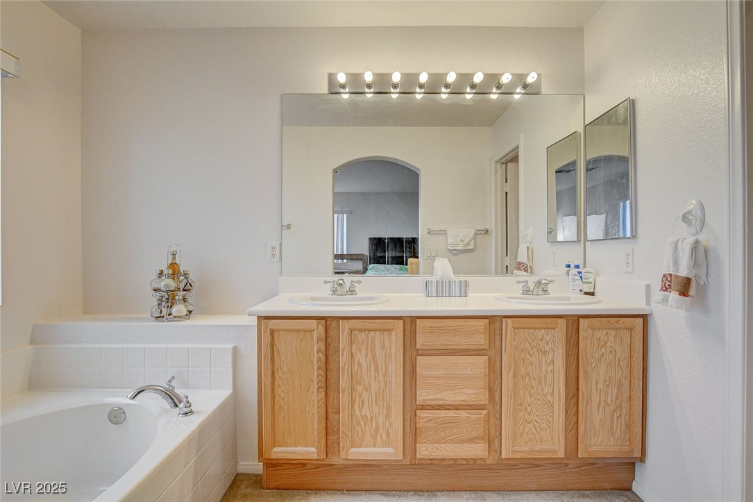 7427 Wagonwheel Ranch Way Las Vegas, NV 89113 - Photo 33 of 50 Full bath with double vanity and a garden tub