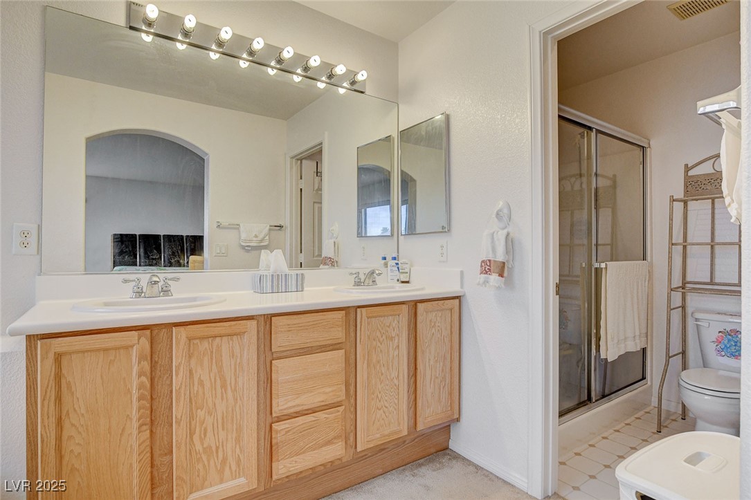 7427 Wagonwheel Ranch Way Las Vegas, NV 89113 - Photo 35 of 50 Full bathroom with a shower stall and double vanity