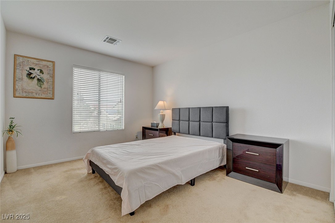 7427 Wagonwheel Ranch Way Las Vegas, NV 89113 - Photo 36 of 50 Bedroom with light carpet and baseboards