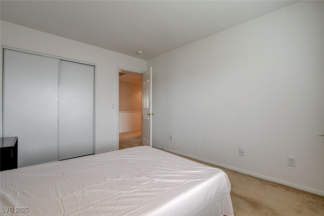 7427 Wagonwheel Ranch Way Las Vegas, NV 89113 - Photo 38 of 50 Bedroom featuring carpet and a closet