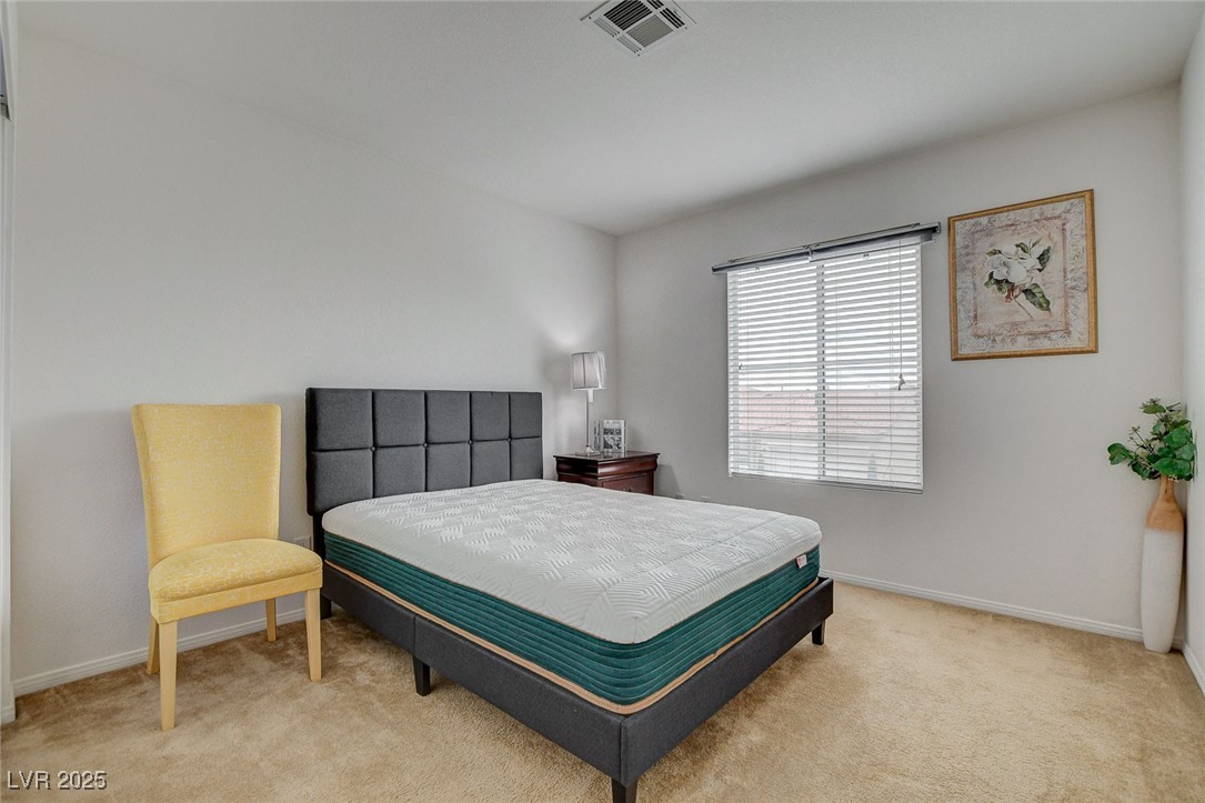 7427 Wagonwheel Ranch Way Las Vegas, NV 89113 - Photo 39 of 50 Bedroom featuring light carpet and baseboards