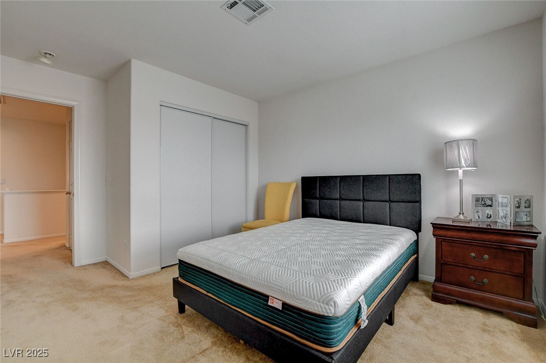7427 Wagonwheel Ranch Way Las Vegas, NV 89113 - Photo 40 of 50 Carpeted bedroom featuring a closet and baseboards