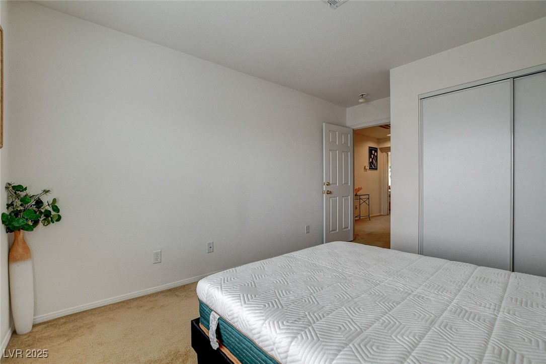 7427 Wagonwheel Ranch Way Las Vegas, NV 89113 - Photo 41 of 50 Bedroom featuring light colored carpet and a closet