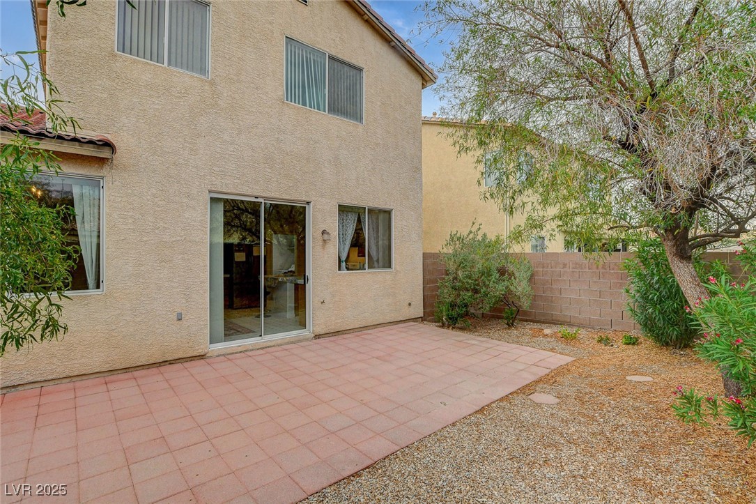 7427 Wagonwheel Ranch Way Las Vegas, NV 89113 - Photo 47 of 50 Back of property featuring stucco siding and a patio area