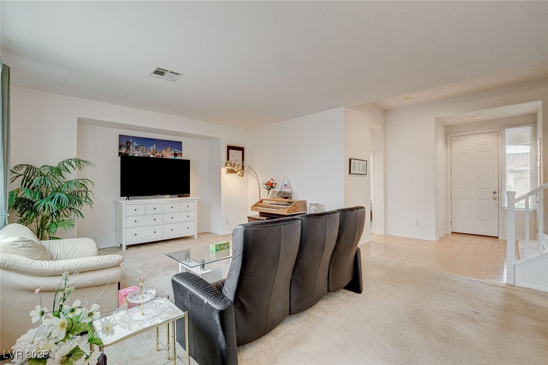7427 Wagonwheel Ranch Way Las Vegas, NV 89113 - Photo 6 of 50 Living area featuring light colored carpet and baseboards