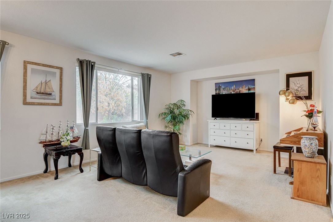 7427 Wagonwheel Ranch Way Las Vegas, NV 89113 - Photo 7 of 50 Living room featuring light colored carpet and baseboards