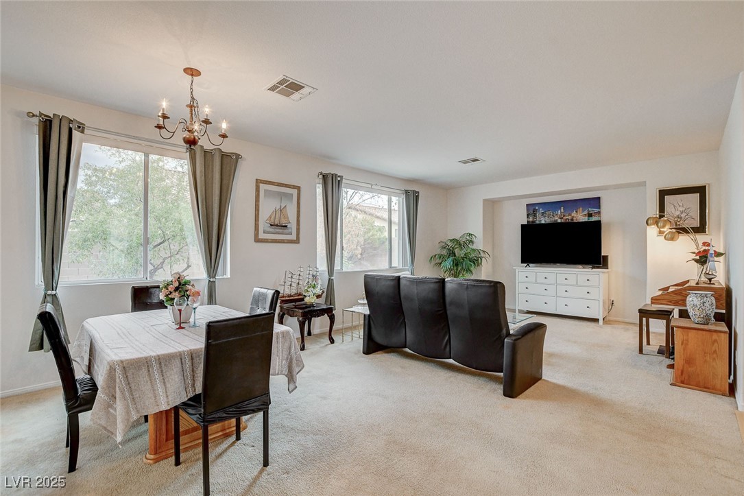 7427 Wagonwheel Ranch Way Las Vegas, NV 89113 - Photo 9 of 50 Dining area featuring a chandelier and light carpet