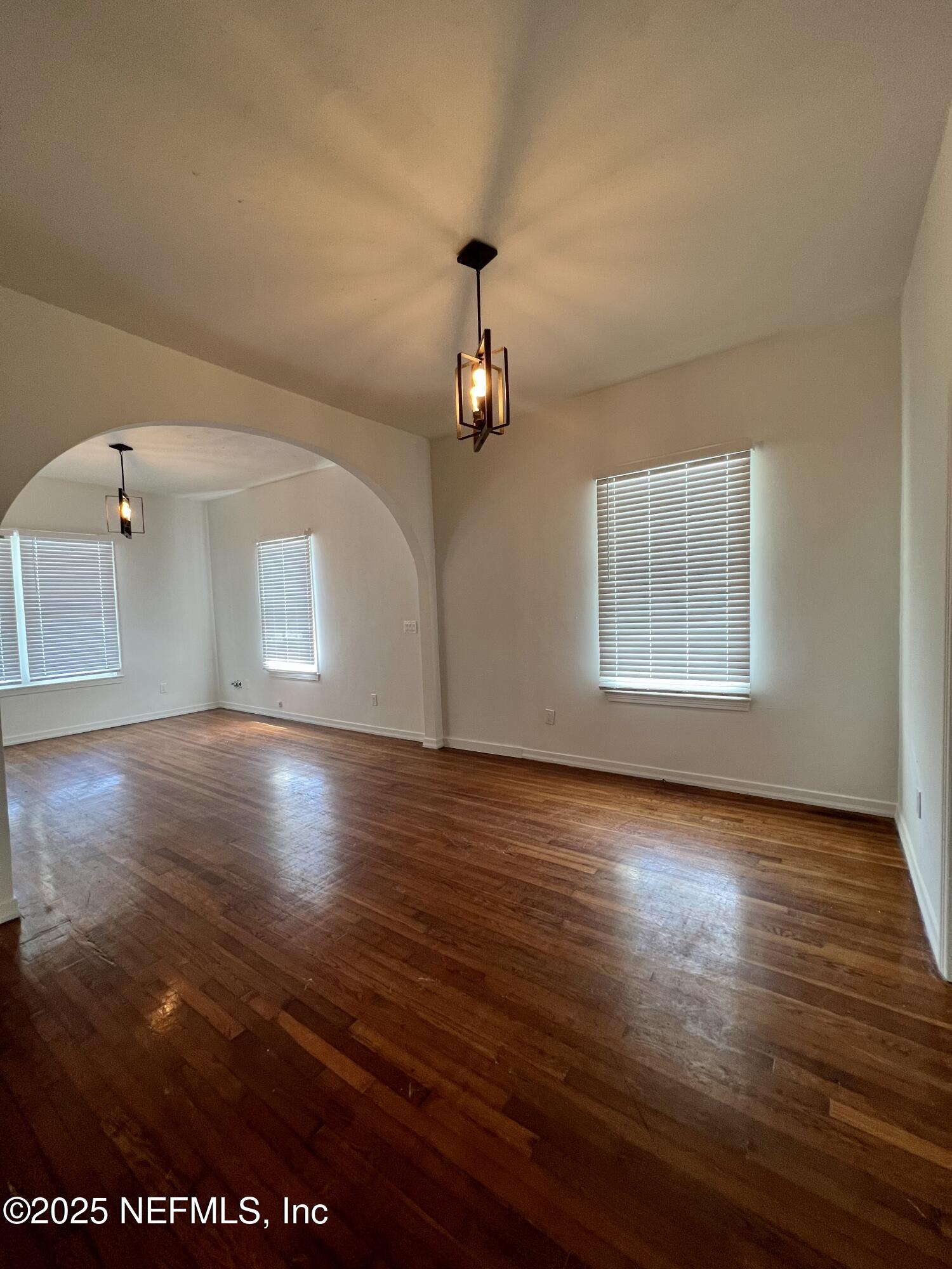 30 Sanford Street, Unit DOWN St. Augustine, FL 32084 - Photo 3 of 14 wooden floor in an empty room with a window