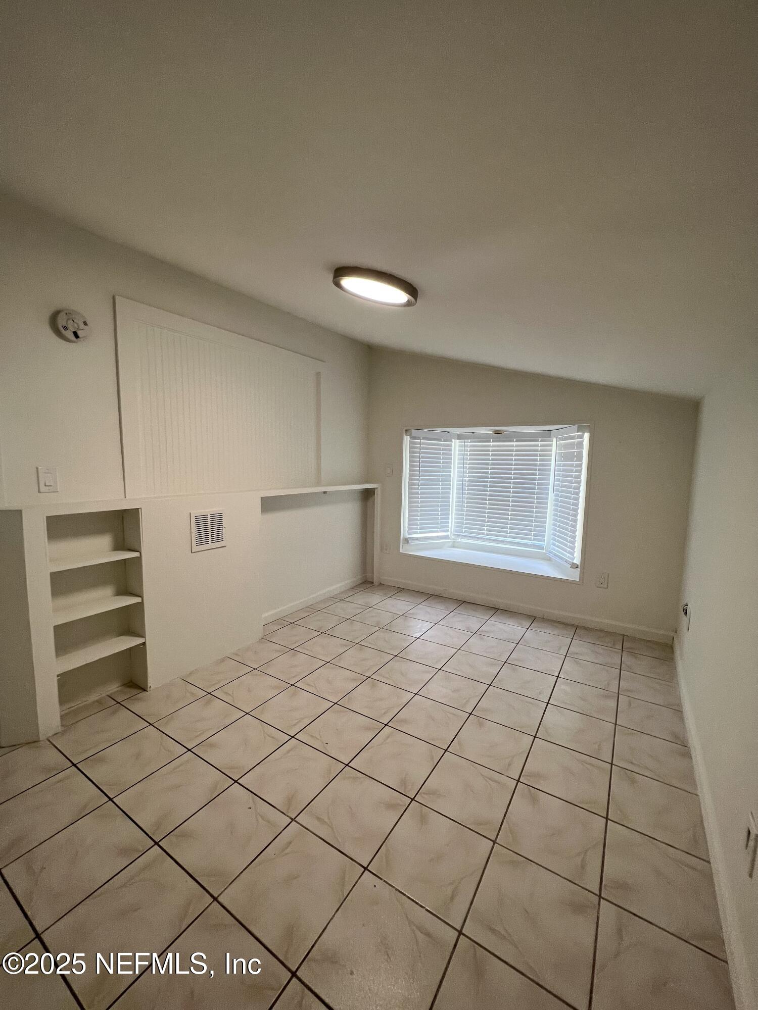 30 Sanford Street, Unit DOWN St. Augustine, FL 32084 - Photo 10 of 14 a view of an empty room and a window