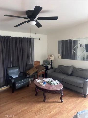 a living room with furniture a rug and a chandelier