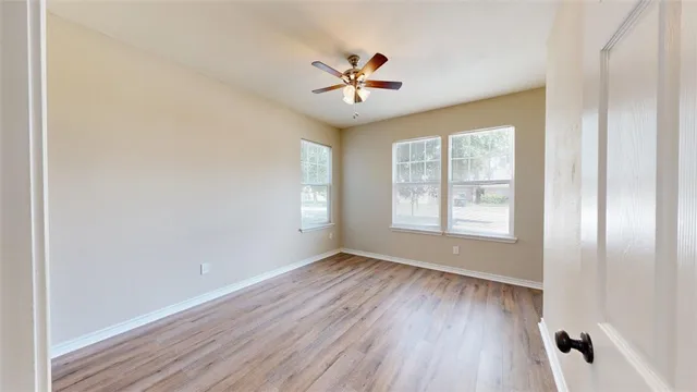 wooden floor in an empty room with a window