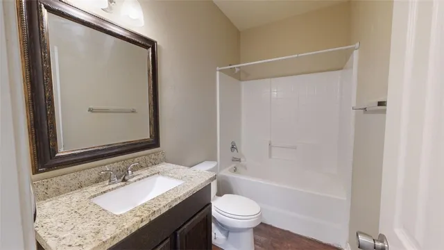 an empty room with wooden floor and ceiling fan