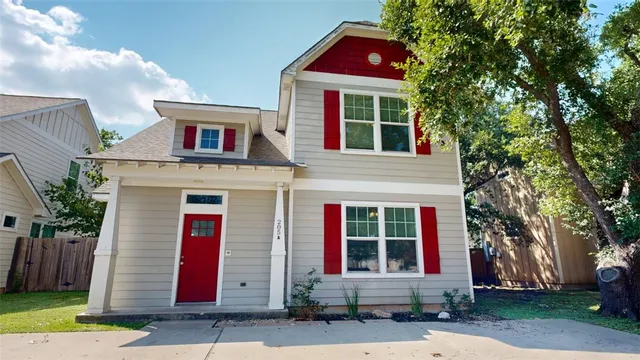 a view of a house with a yard and tree