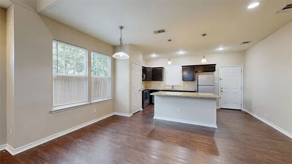 a view of kitchen with cabinets microwave and stove