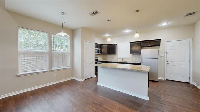 a view of kitchen with sink and wooden floor