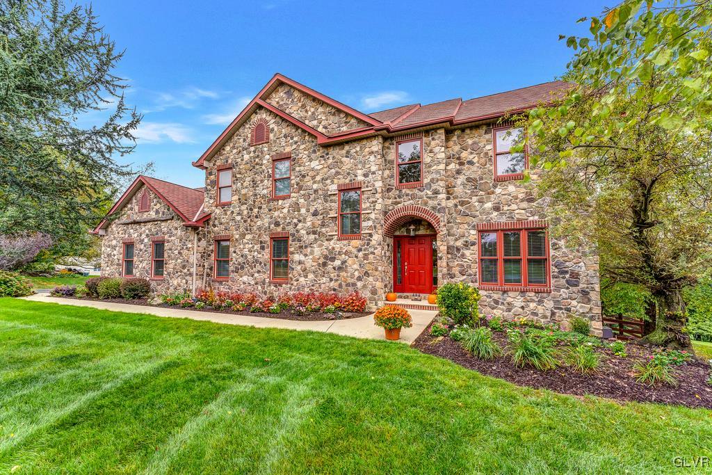 a front view of house with yard and green space