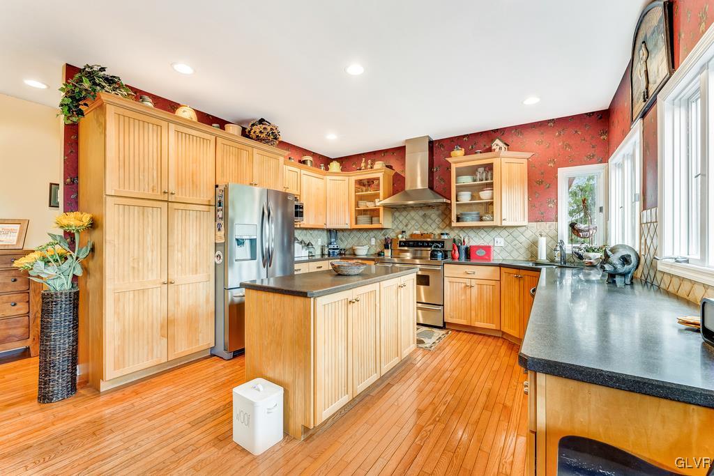 131 Blackstone Drive Wind Gap, PA 18091 - Photo 21 of 50 a kitchen with stainless steel appliances granite countertop a refrigerator a stove and white cabinets with wooden floors