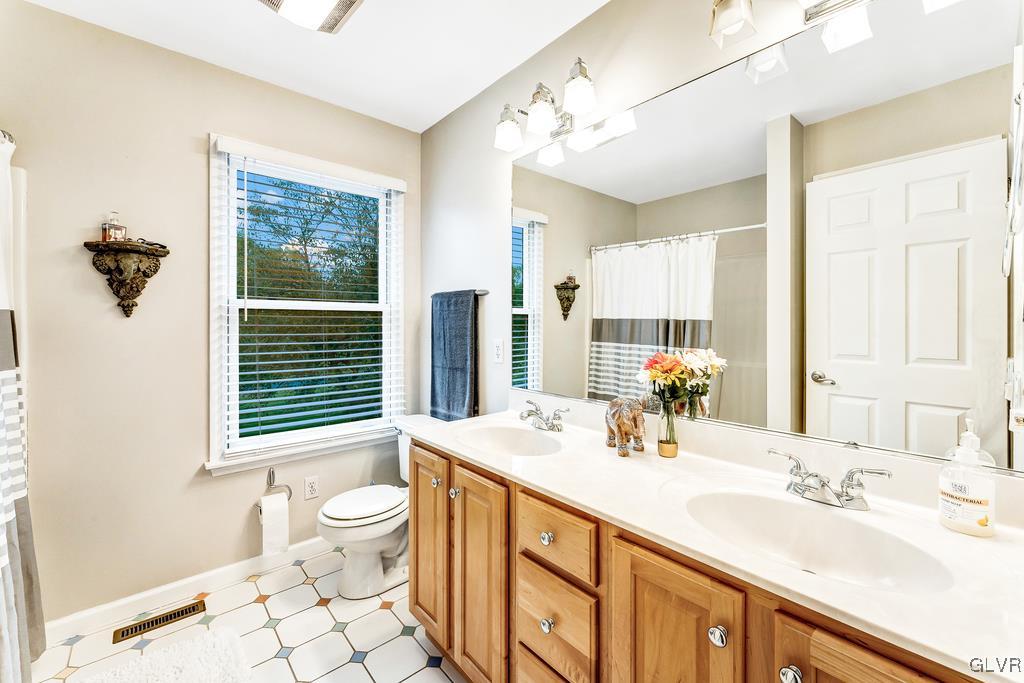 131 Blackstone Drive Wind Gap, PA 18091 - Photo 32 of 50 a bathroom with a double vanity sink toilet and shower