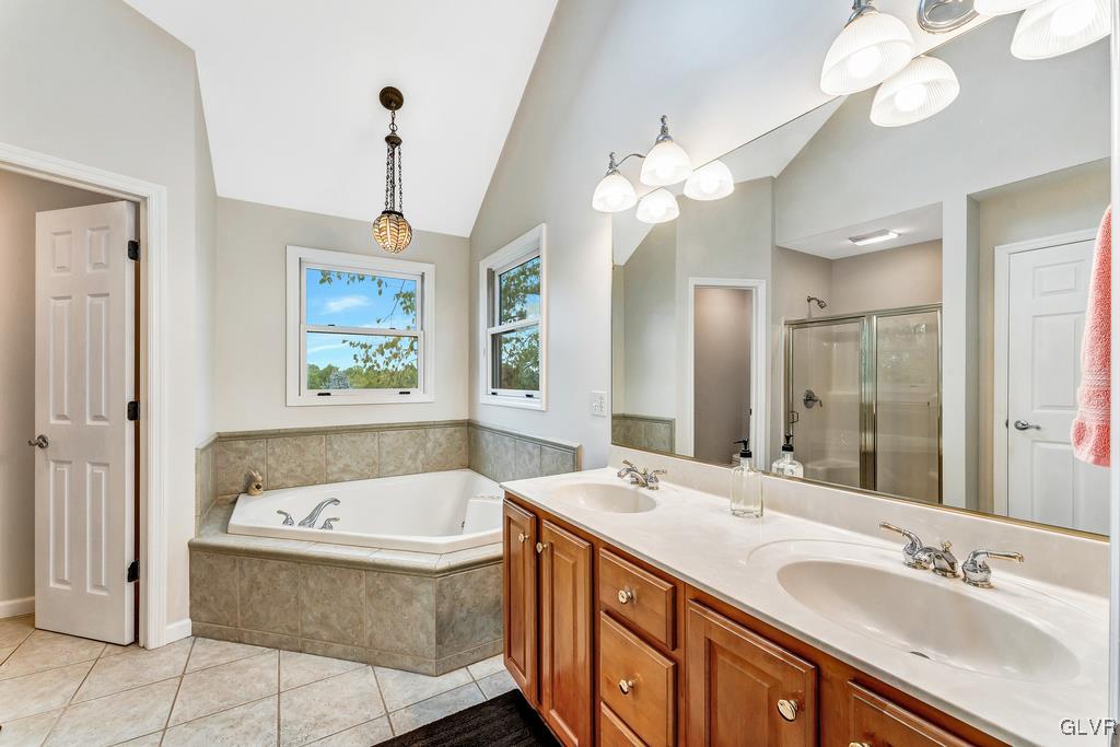 131 Blackstone Drive Wind Gap, PA 18091 - Photo 35 of 50 a bathroom with a tub a double vanity sink and a mirror