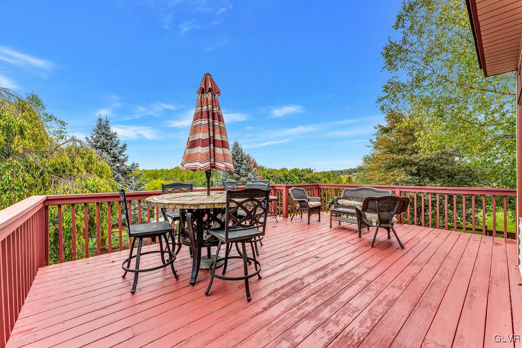 131 Blackstone Drive Wind Gap, PA 18091 - Photo 45 of 50 a view of a roof deck with table and chairs and wooden floor