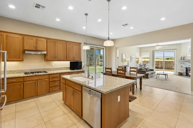 a dining area with furniture and a floor to ceiling window