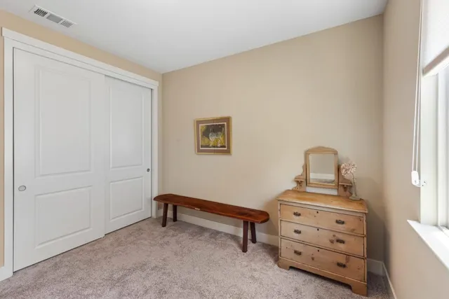 a bedroom with a bed and chair