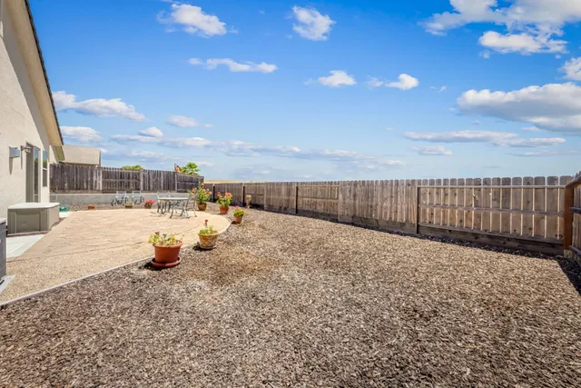 a front view of house with garage and flowers
