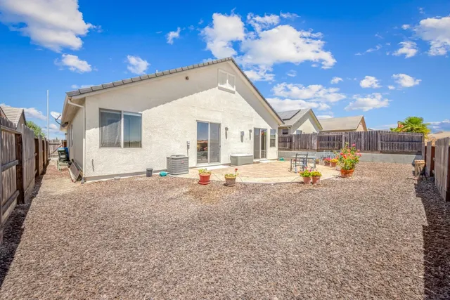 a view of an house with backyard space and balcony