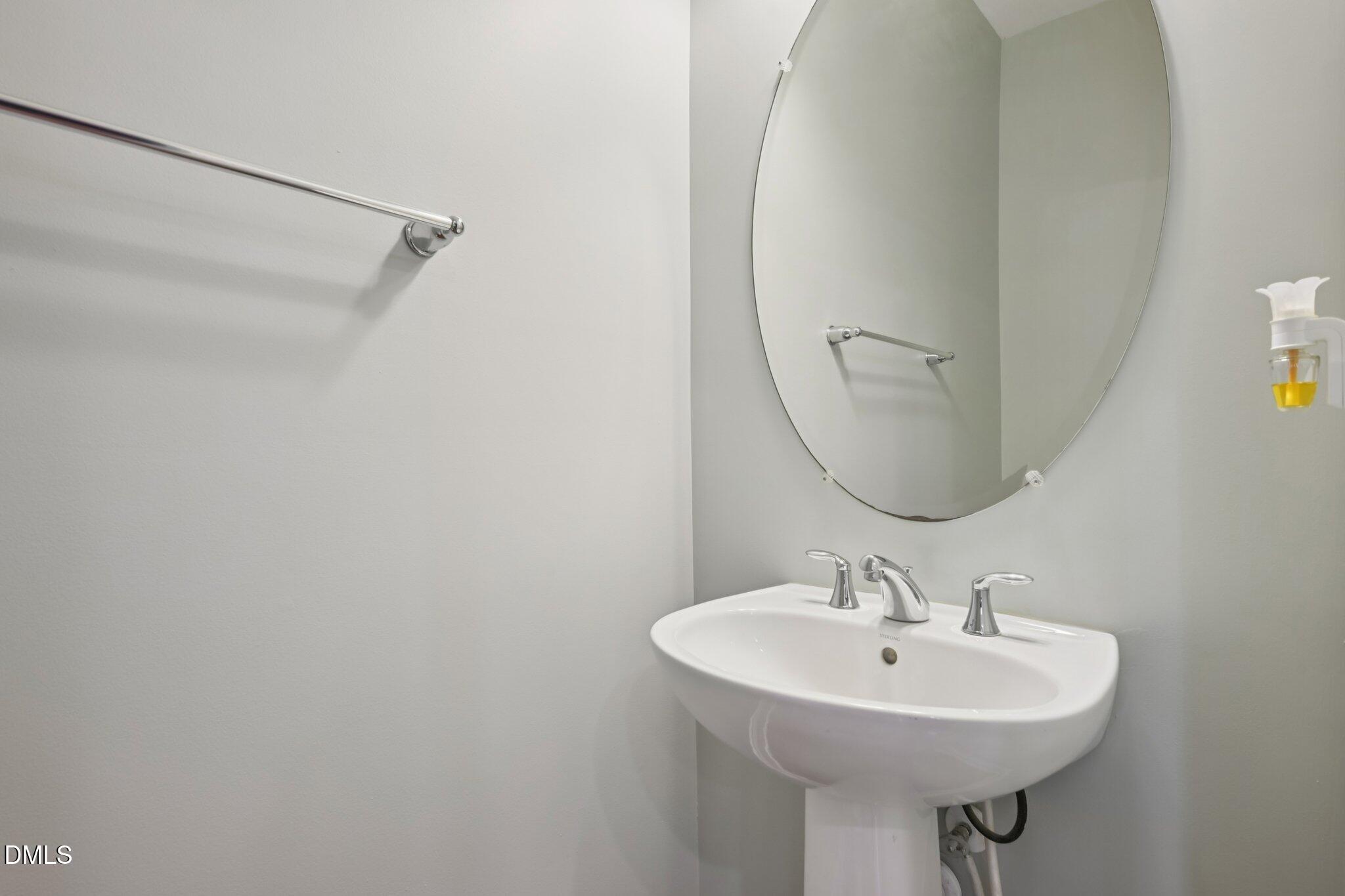 10510 Sablewood Drive, Unit 113 Raleigh, NC 27617 - Photo 33 of 38 a bathroom with a sink a mirror and a vanity