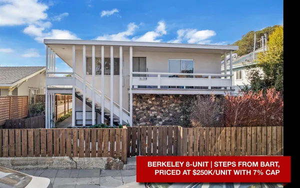a view of a house with wooden fence