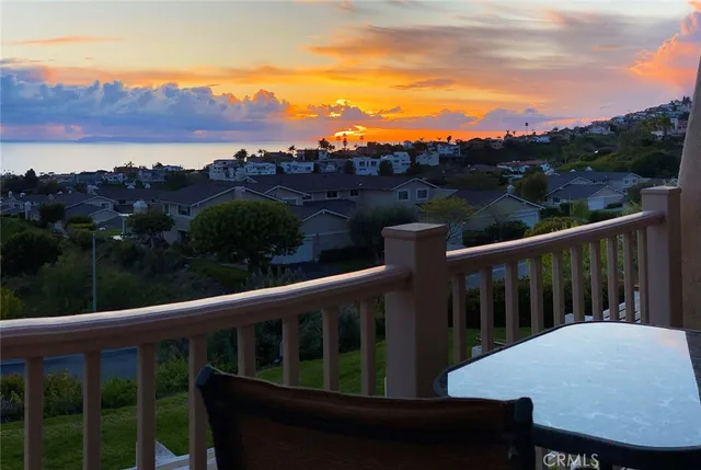 a view of a balcony with wooden floor and a floor to ceiling window