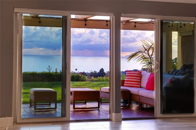 a view of a porch with chairs and a yard