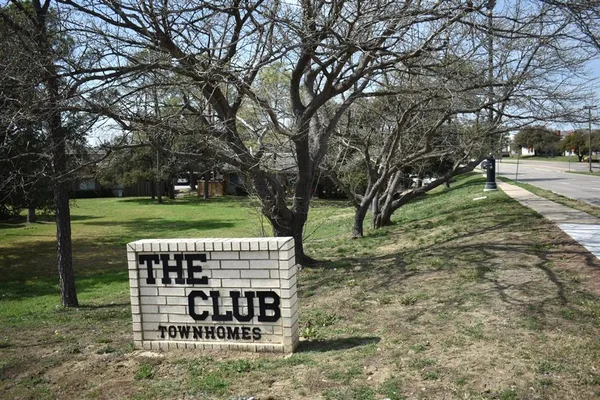 a view of a park with large trees