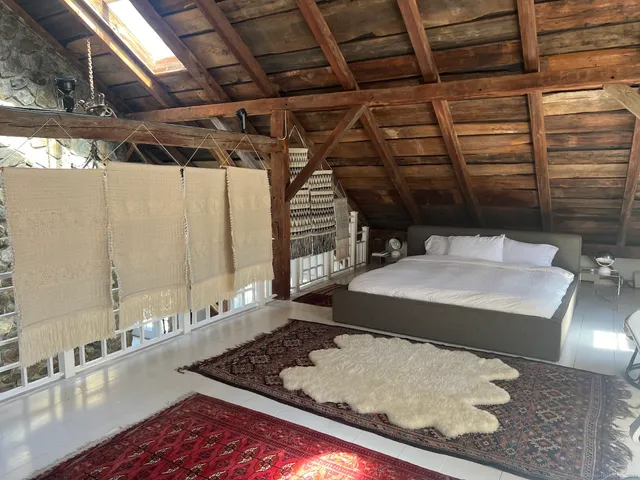 a bed sitting in a room next to a bathroom