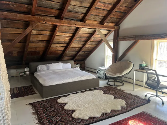 a room with water heater and wooden floors