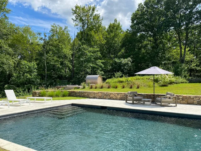 a swimming pool with an outdoor seating