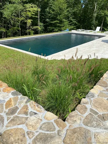 a view of a swimming pool with a yard