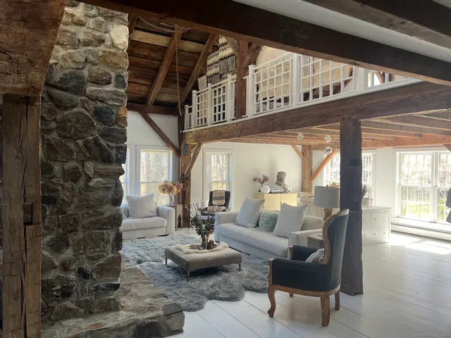 a living room with furniture and a floor to ceiling window