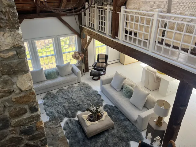 a living room with furniture and a floor to ceiling window