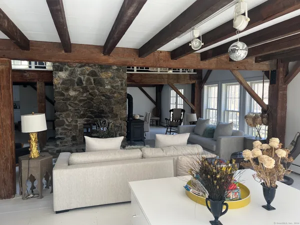 a living room with furniture and a chandelier