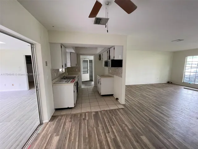 a view of kitchen with furniture and wooden floor