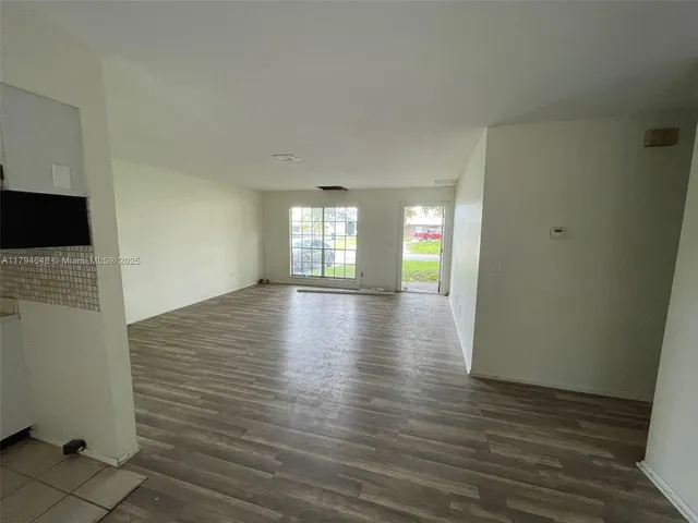 a view of wooden floor and windows in a room