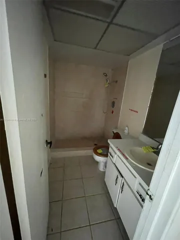 a bathroom with a toilet sink and shower