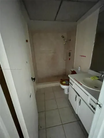 a view of a room with a ceiling fan and a window